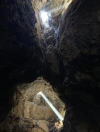 Lights from opening in lava tube cave