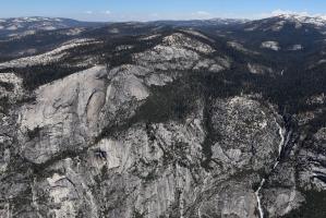 View from top of Half Dome with waterfall in distance