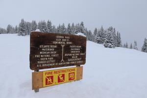 Continental divide sign seen while it snows