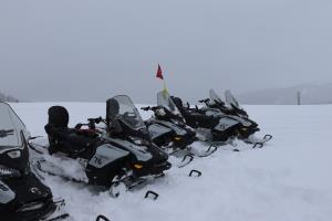 Snowmobiles parked at continental divide