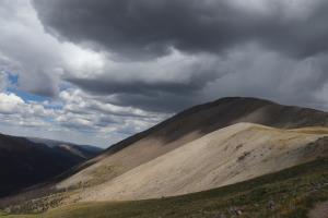 Looking back at San Luis Peak with dark clouds