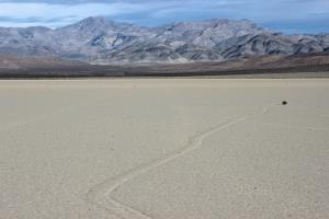 Sailing stone in Racetrack Playa with mountain in background