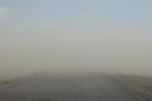 Road with dust storm straight ahead