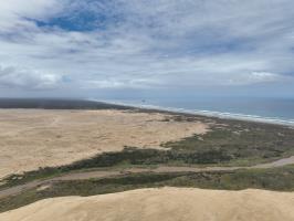 Drone view of sand dunes, river and with ocean