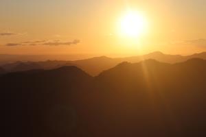 Setting sun and mountains seen from top of Pinnacles