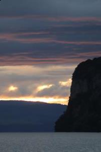 Sunset clouds and lake with cliff