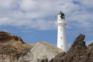 Castlepoint Lighthouse with rocks seen from Deliverance Cove