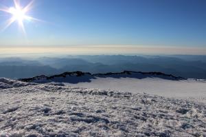 View of Crater Rim on summit of Mt. Rainier with climbers on the right