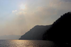 Sun shining through forest fire smoke on Crater Lake