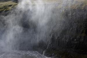 Mist from Dettifoss waterfall against rocks