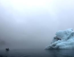 Zodiac boat near iceberg to give scale