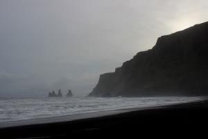 Basalt rock formation at Black Sand Beach at a distance