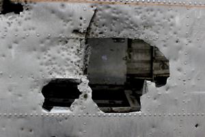 Close up of hole in plane with vandalism of plane