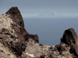 Mt. Shasta with rocks and butterflies around it seen from path to true summit of Lassen Peak