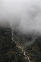 Fog above long waterfall